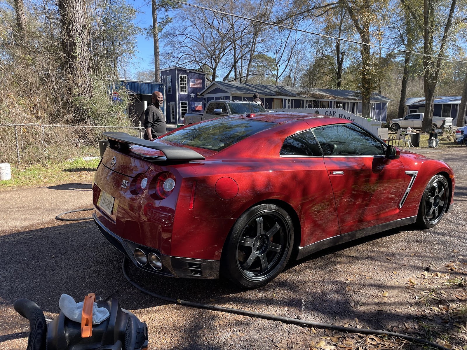 The owner hand-detailing a Nissan GT-R at BK's Hand Car Wash